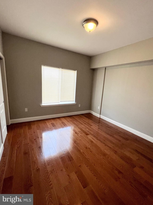 unfurnished bedroom with dark hardwood / wood-style floors