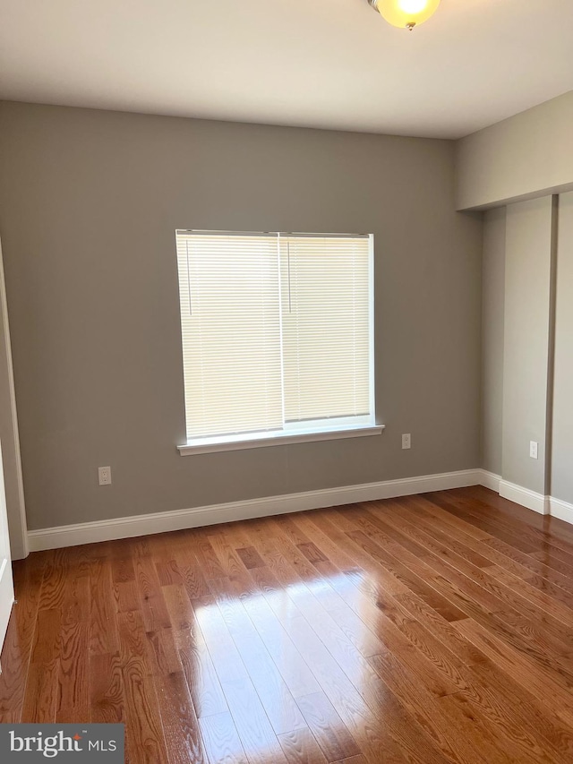 spare room with hardwood / wood-style flooring