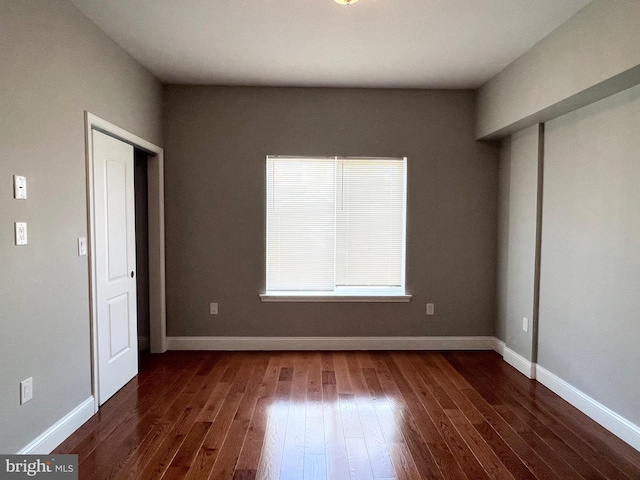 unfurnished bedroom featuring dark wood-type flooring