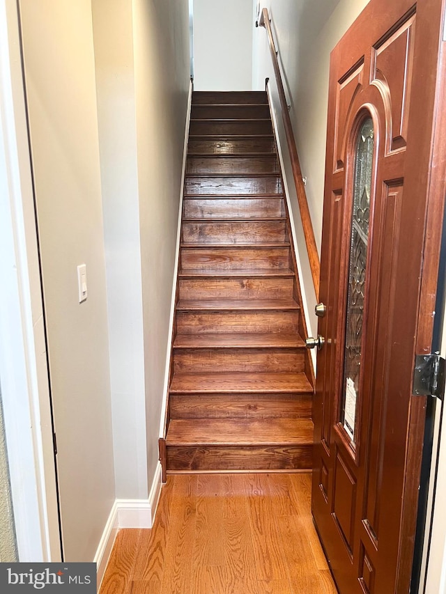 stairway featuring hardwood / wood-style flooring