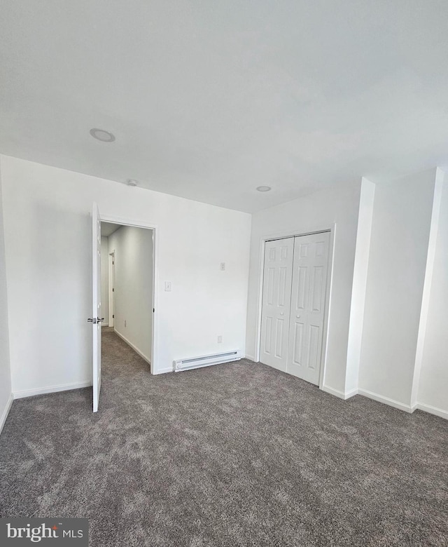 1005 N Spruce St, Wilmington, DE 19801 - unfurnished bedroom with carpet, baseboard heating, baseboards, and a closet