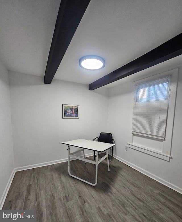 office with dark wood-type flooring and beamed ceiling