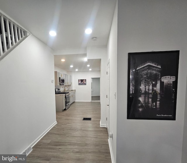 corridor featuring hardwood / wood-style flooring