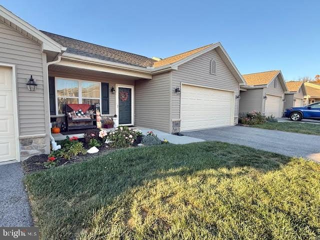 single story home featuring a garage and a front yard