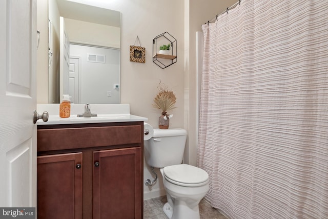 bathroom featuring toilet and vanity