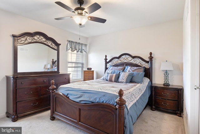 bedroom with light carpet and a ceiling fan
