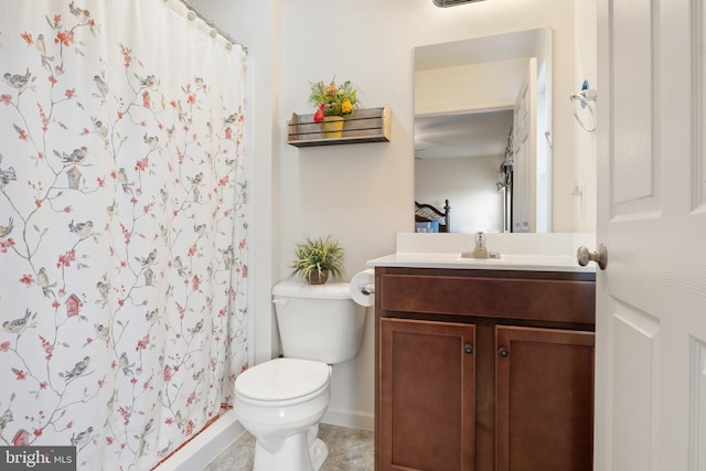 bathroom featuring curtained shower, vanity, tile patterned floors, and toilet