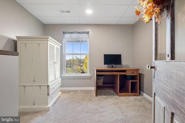 office space with carpet, a paneled ceiling, and baseboards