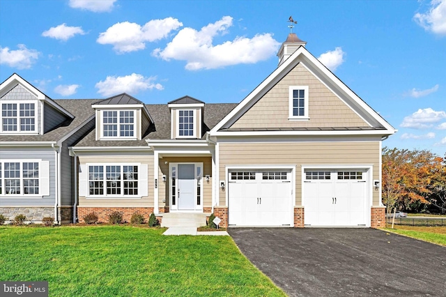 view of front of home with a garage and a front lawn