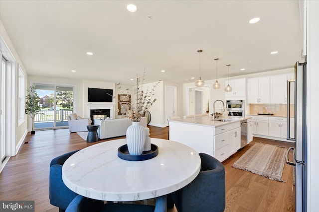 dining space featuring wood-type flooring and sink