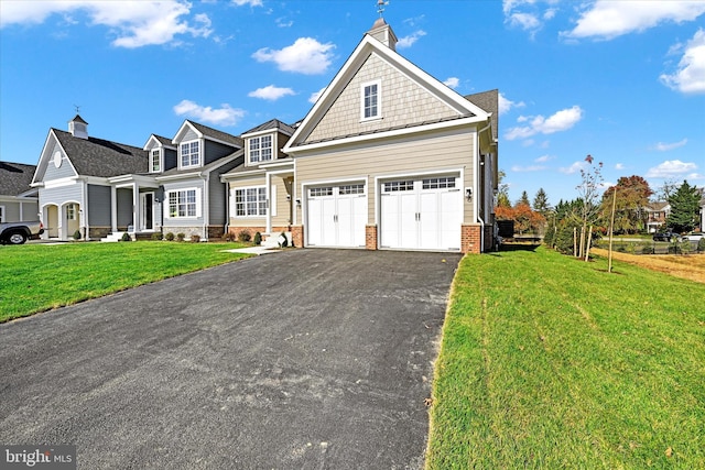 view of front of property featuring a garage and a front lawn