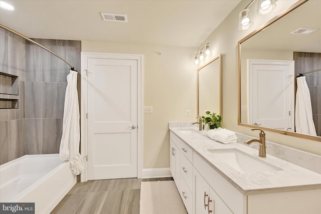 bathroom featuring shower / bath combination with curtain and vanity