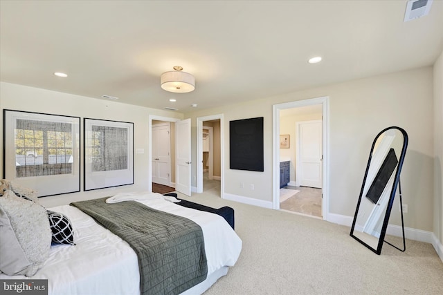 bedroom with access to exterior, light colored carpet, and ensuite bath