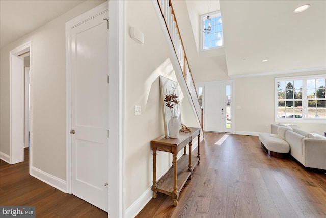 entrance foyer with wood-type flooring and a notable chandelier