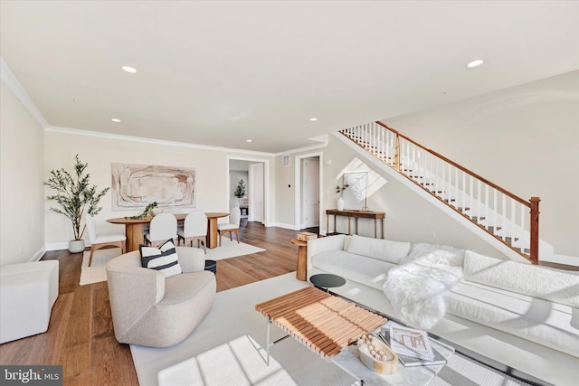 living room with wood-type flooring and ornamental molding