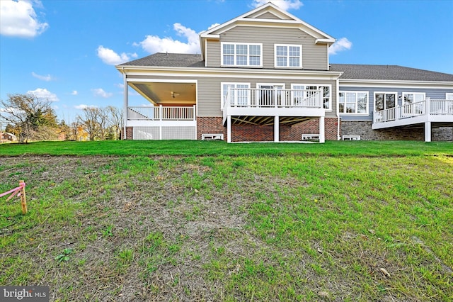 back of house featuring a yard and a wooden deck