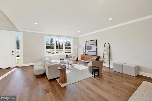 living room featuring light wood-type flooring and crown molding