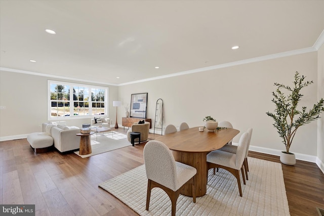 dining room with hardwood / wood-style floors and ornamental molding