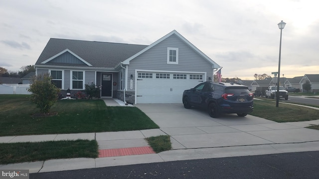 view of front of property featuring a yard and a garage