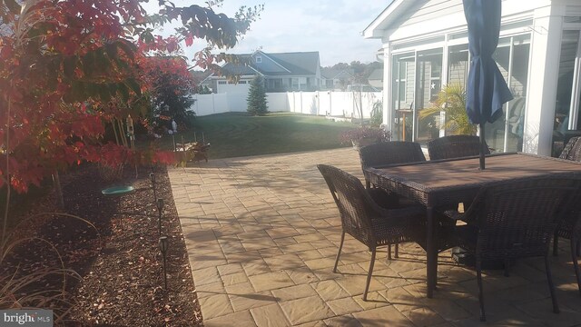 view of patio featuring a sunroom