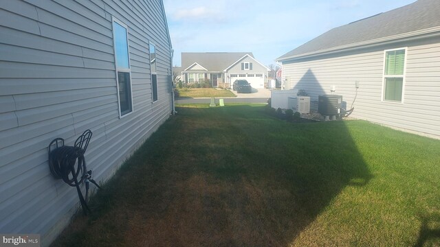 view of yard featuring central air condition unit