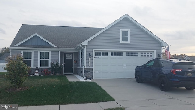 view of front of home with a yard and a garage