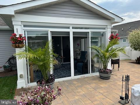 rear view of house featuring a sunroom