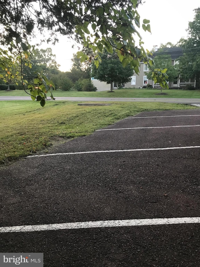 view of car parking with a lawn