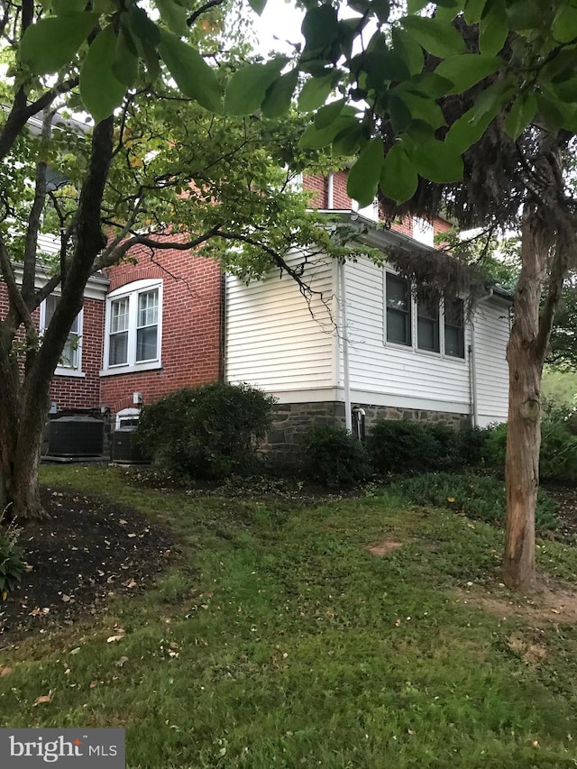 view of home's exterior with central AC unit