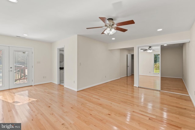 unfurnished living room with french doors, light hardwood / wood-style floors, and ceiling fan