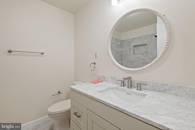 bathroom with a shower, vanity, and toilet