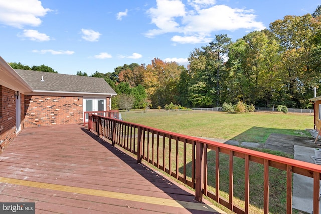 wooden terrace featuring a yard