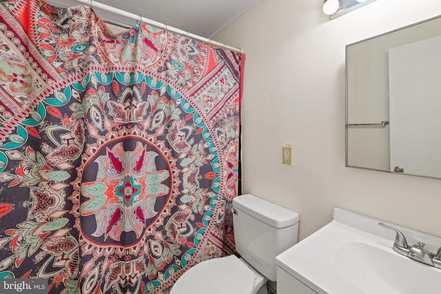 bathroom featuring vanity, toilet, and walk in shower