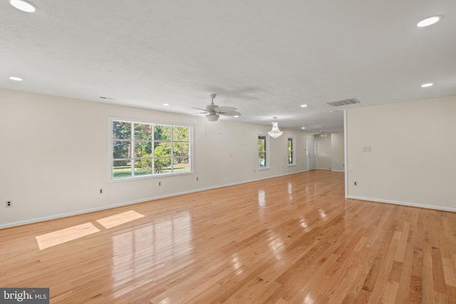 unfurnished room with ceiling fan and light wood-type flooring