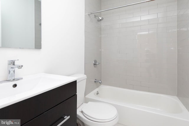 full bathroom featuring vanity, toilet, and tiled shower / bath combo