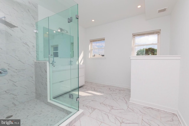 bathroom with walk in shower and vanity