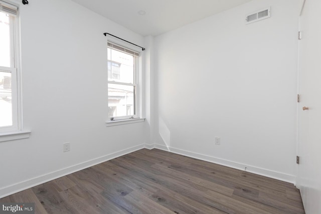 spare room with dark hardwood / wood-style flooring