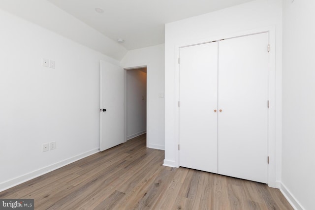 unfurnished bedroom featuring light hardwood / wood-style floors and a closet