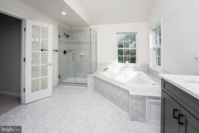 bathroom featuring tile patterned flooring, vanity, separate shower and tub, and lofted ceiling