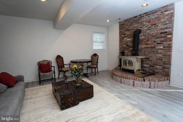 living room featuring a wood stove and light wood-type flooring