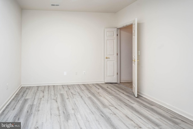 unfurnished room with light hardwood / wood-style flooring