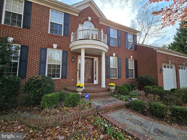 view of front of property featuring a garage and a balcony