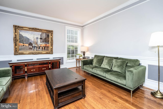 living room with wood-type flooring and crown molding