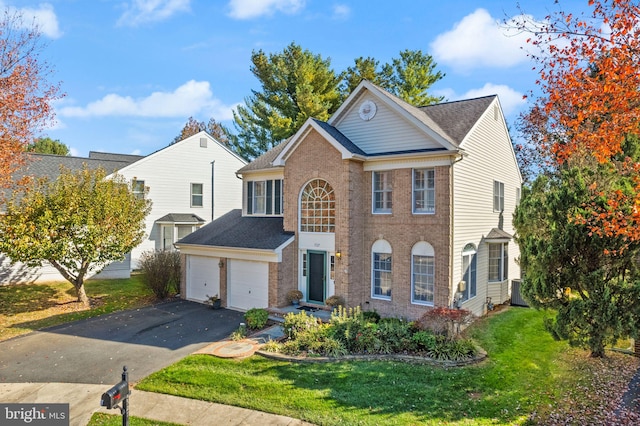 view of front of house with a garage and a front yard