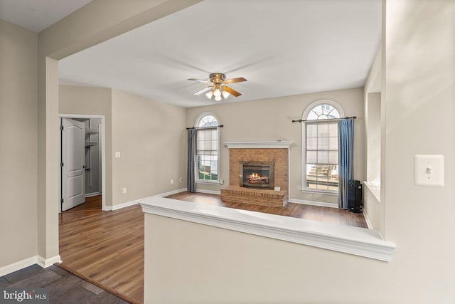 unfurnished living room featuring a wealth of natural light, hardwood / wood-style flooring, and ceiling fan