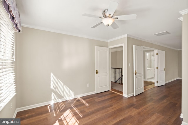 spare room featuring dark hardwood / wood-style flooring, ceiling fan, and ornamental molding