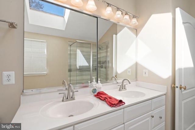 bathroom featuring vanity, a skylight, and a shower with door