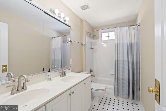 full bathroom with vanity, shower / tub combo with curtain, tile patterned floors, and toilet