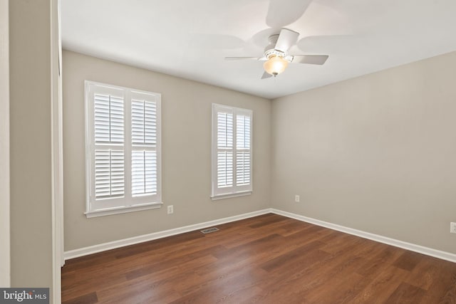 empty room featuring dark hardwood / wood-style flooring and ceiling fan