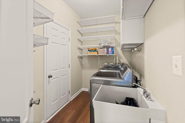 clothes washing area featuring dark hardwood / wood-style floors, sink, and separate washer and dryer